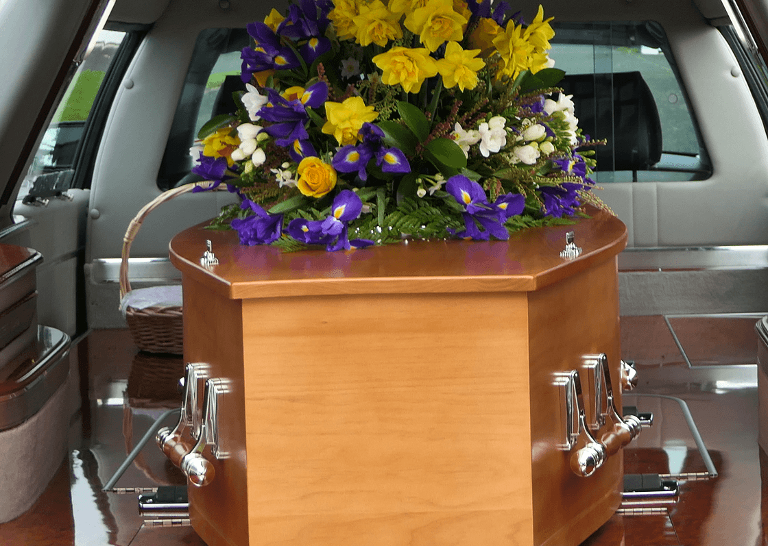 Wooden coffin with colorful floral arrangement